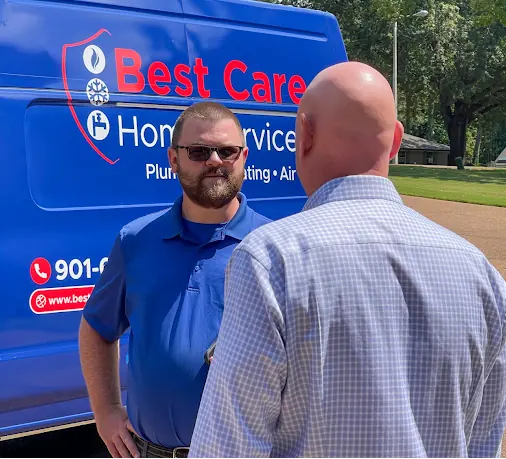 Best Care technician talking with a homeowner beside a service van